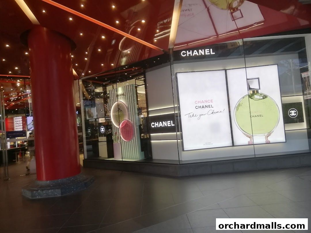 The exterior of a Chanel Beauty Boutique with large displays showcasing perfume.