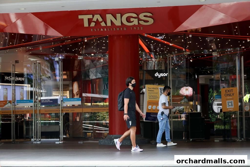 The entrance of the TANGS department store with people walking by.