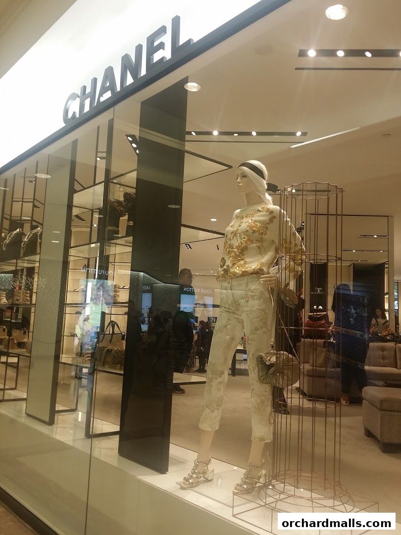 Chanel Beauty Boutique storefront with a mannequin displaying a stylish outfit.