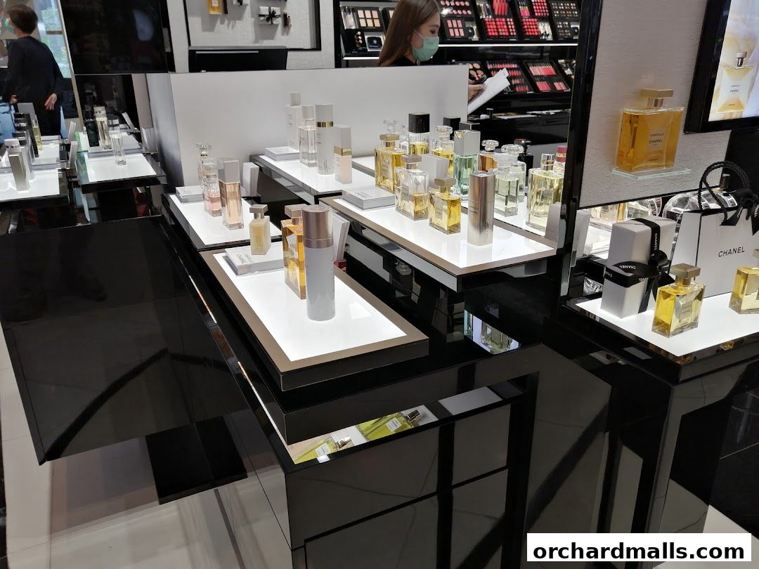 A display of Chanel perfumes and beauty products in a well-lit boutique.
