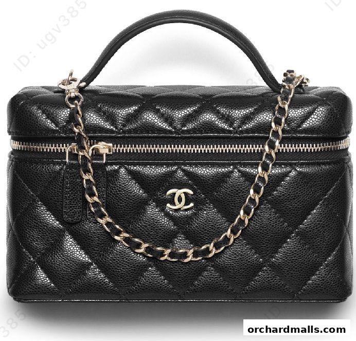 A black Chanel vanity case with quilted leather and a gold chain.