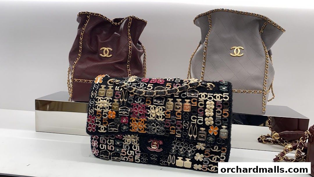 Chanel handbags displayed with iconic logos and decorative elements.