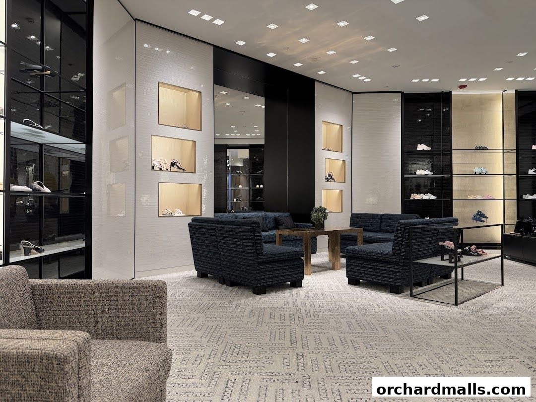 Interior view of a luxurious Chanel store showcasing shoes and handbags on display shelves.