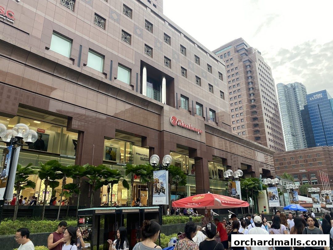 Exterior view of a large department store with multiple shops and a busy street scene.