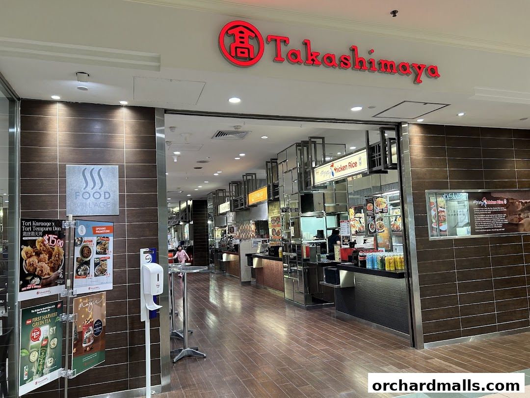 The entrance to Takashimaya Food Village, featuring various food stalls and promotional posters.