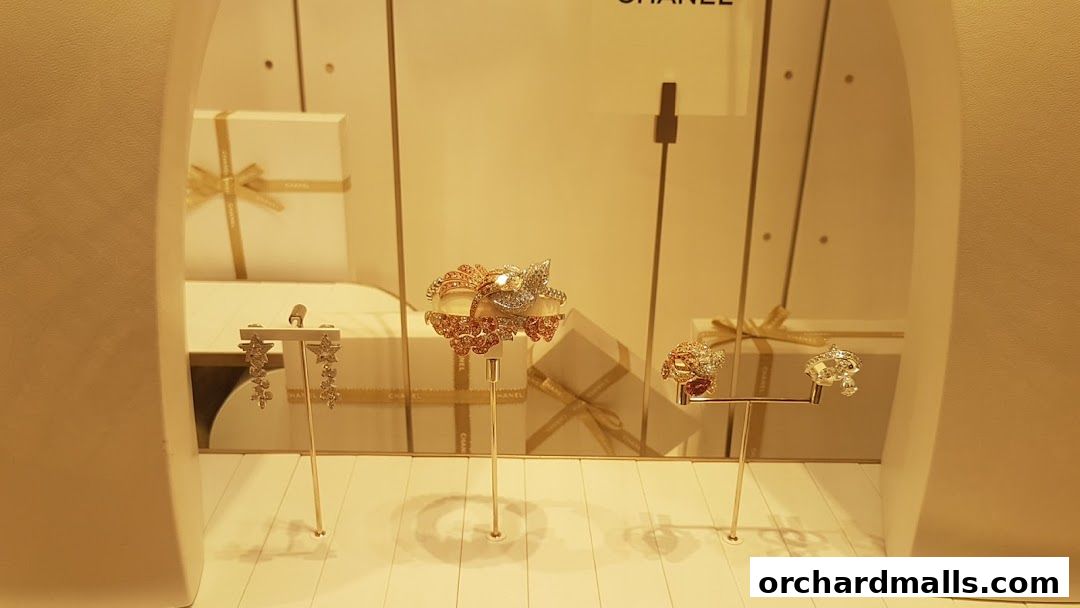 Chanel watches and fine jewelry displayed in a well-lit shop window.