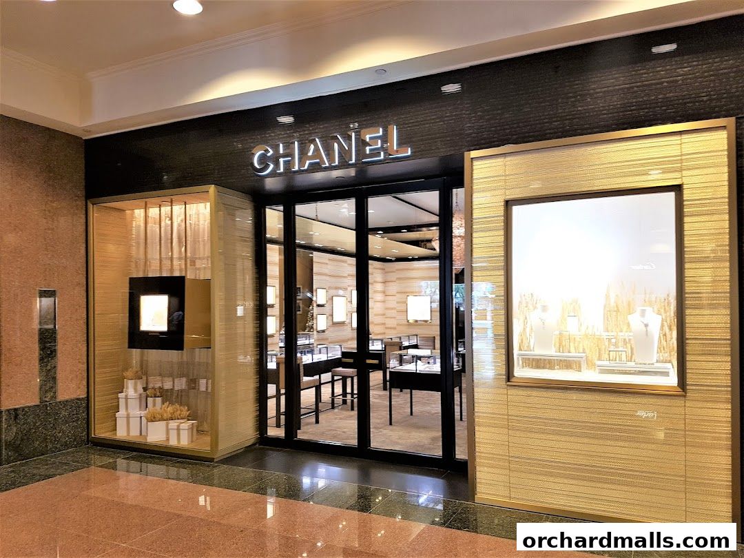The elegant entrance of a Chanel Watches and Fine Jewellery store with illuminated displays.
