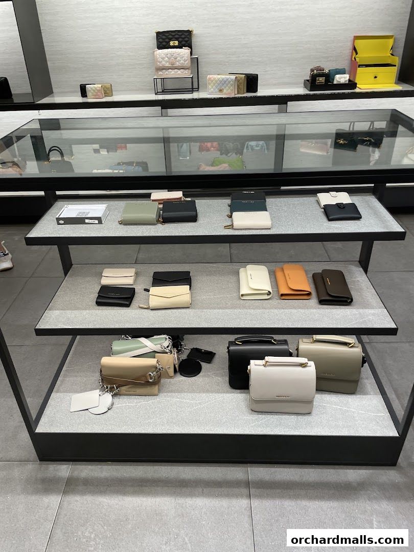 A display of various Charles & Keith wallets and handbags in different colors and styles.