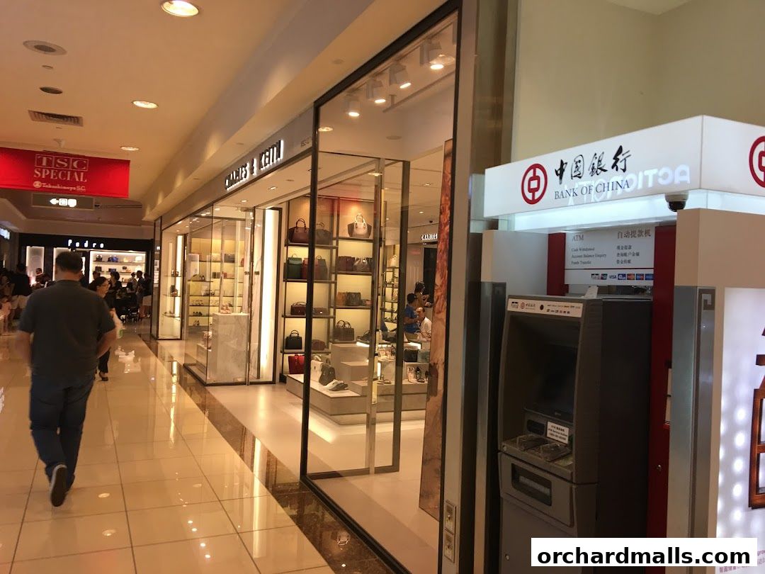 Charles & Keith store entrance with handbags and shoes displayed in a mall.