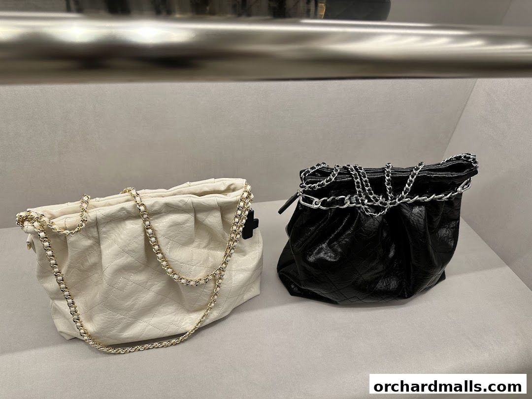 Two stylish quilted handbags, one white and one black, with chain straps.