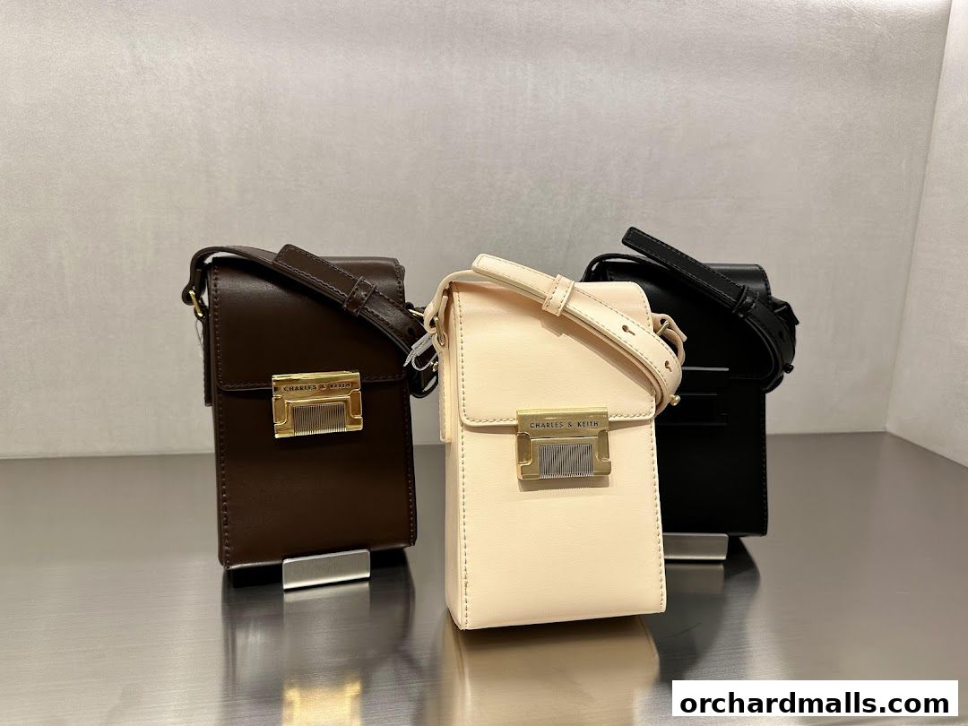 Three stylish Charles & Keith crossbody bags in brown, cream, and black.