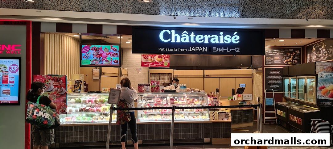 Châteraisé patisserie shop with a display of cakes and pastries, and customers browsing.