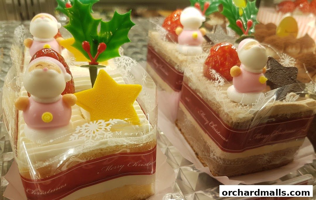 Close-up of festive Christmas cakes decorated with Santa figures and stars.