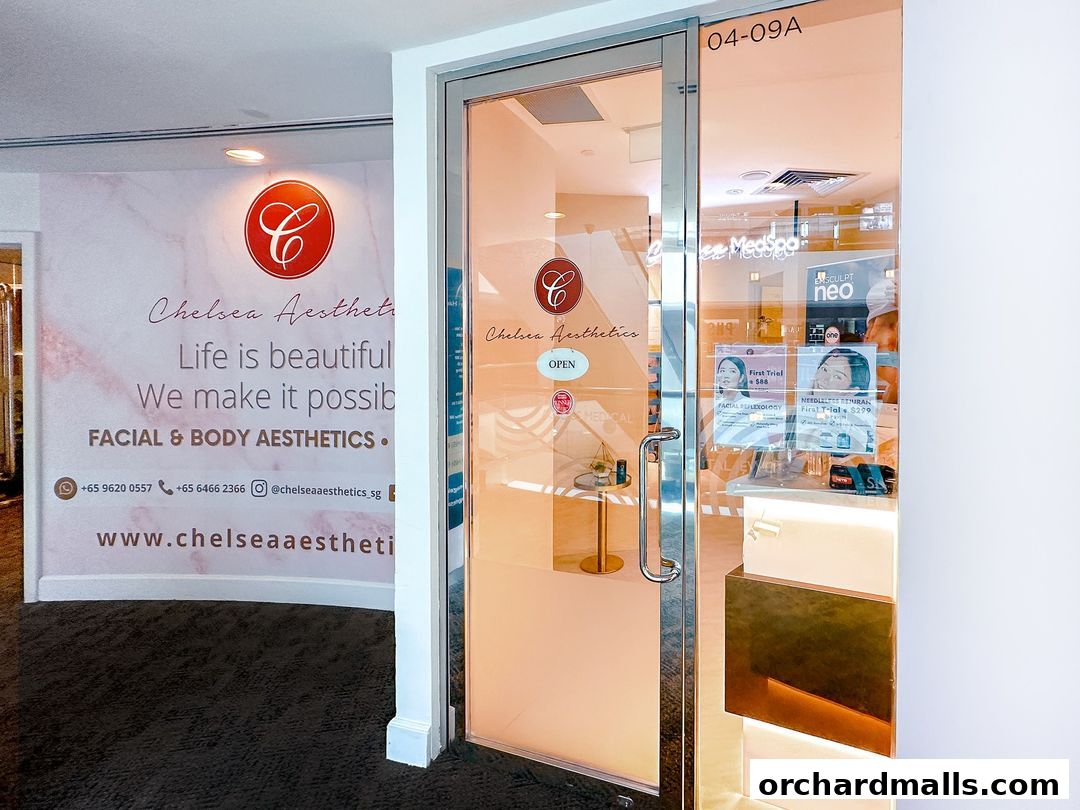 Entrance to Chelsea Aesthetics, a facial and body aesthetics clinic, with promotional posters visible.