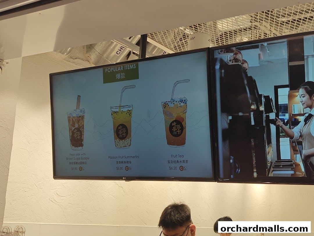 Digital menu board displaying popular bubble tea drinks with prices.