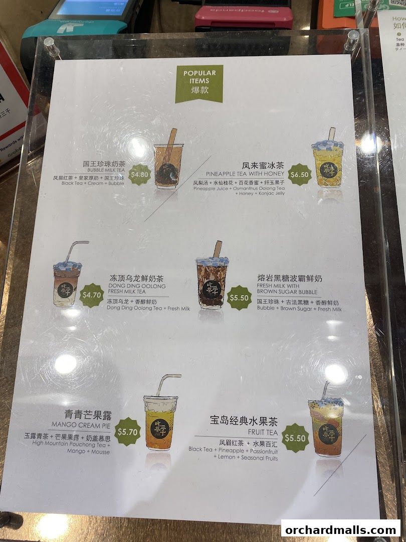 A menu board displaying popular bubble tea and fruit tea drinks with prices.