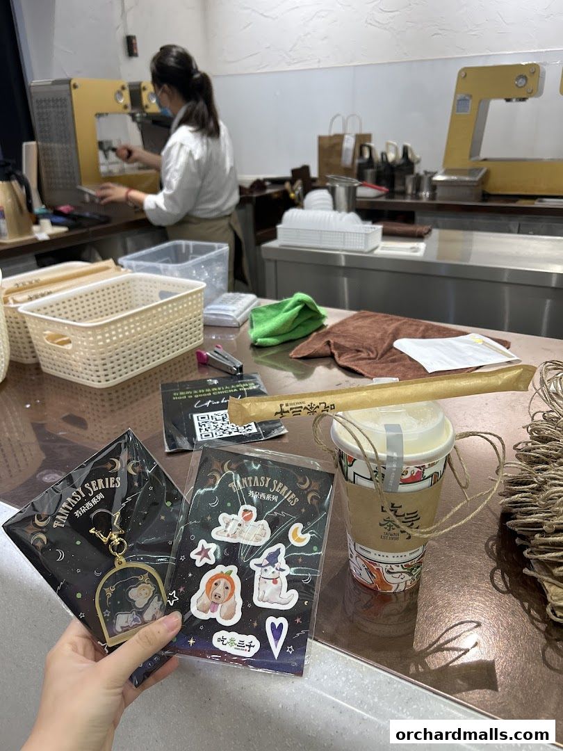 A hand holds merchandise and a drink from CHICHA San Chen.
