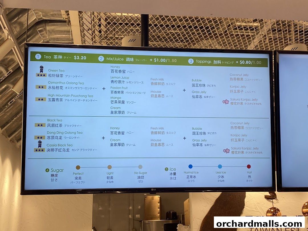 A digital menu board displaying tea types, flavors, toppings, sugar, and ice options.