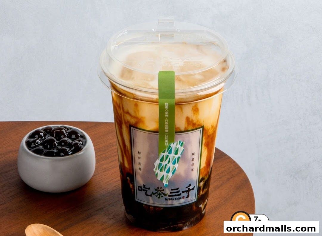 A cup of brown sugar bubble tea with pearls and a sugar percentage indicator.