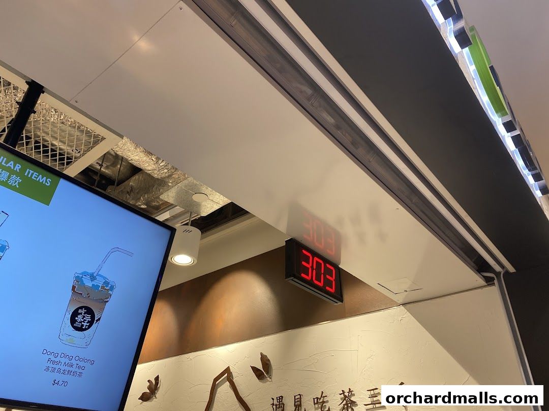 A digital menu displays a Dong Ding Oolong Fresh Milk Tea with price.