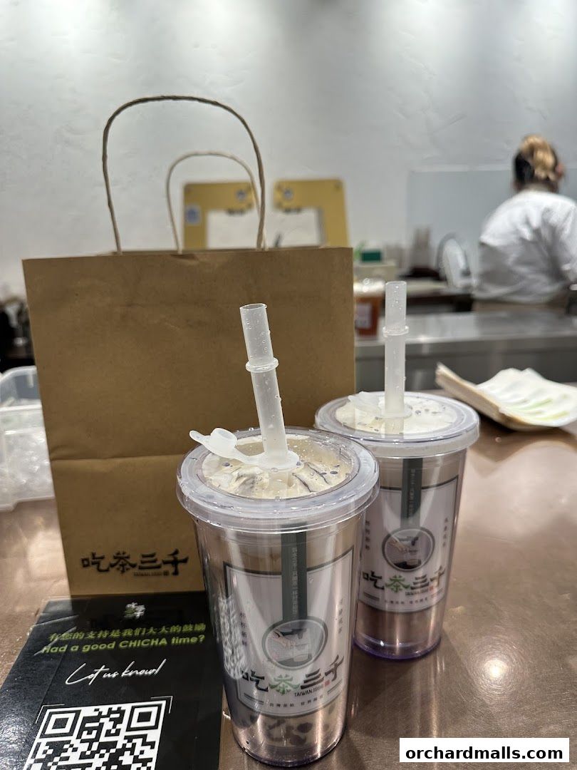 Two bubble tea drinks from CHICHA San Chen with a branded paper bag.
