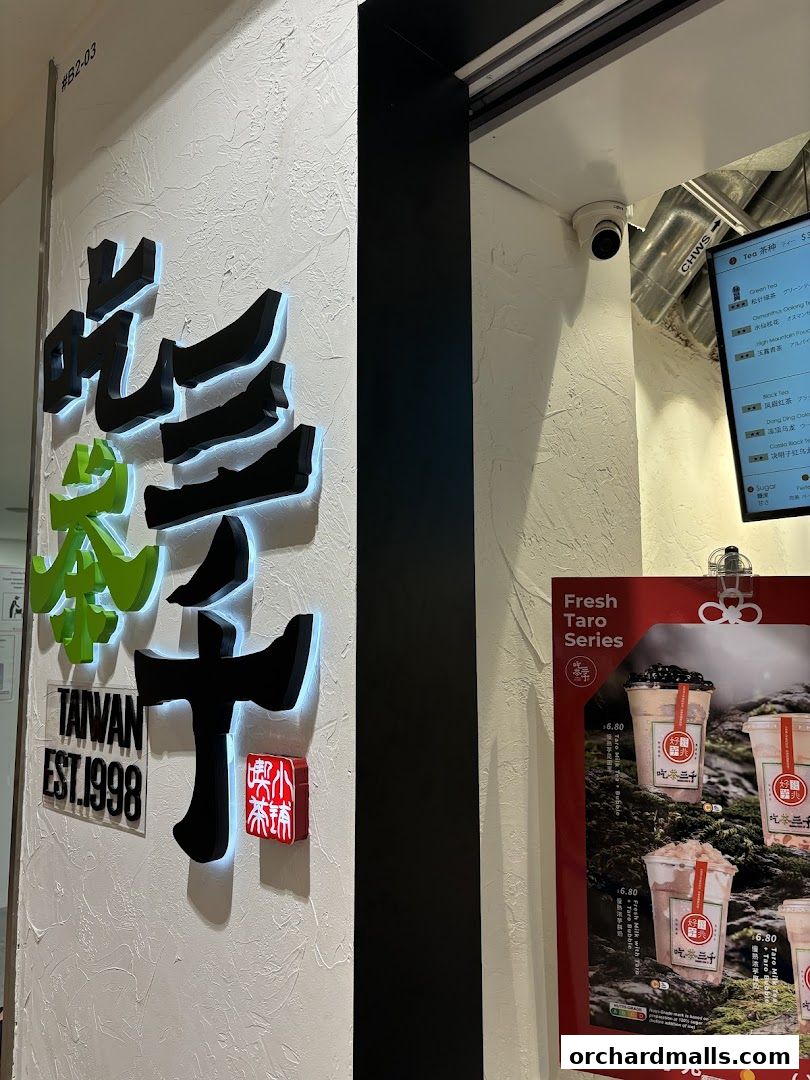 The exterior of CHICHA San Chen Ngee Ann City with illuminated signage and a menu display.
