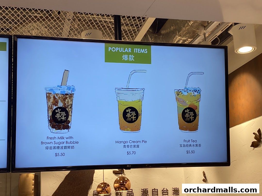 A digital menu board displaying popular bubble tea drinks with illustrations and prices.