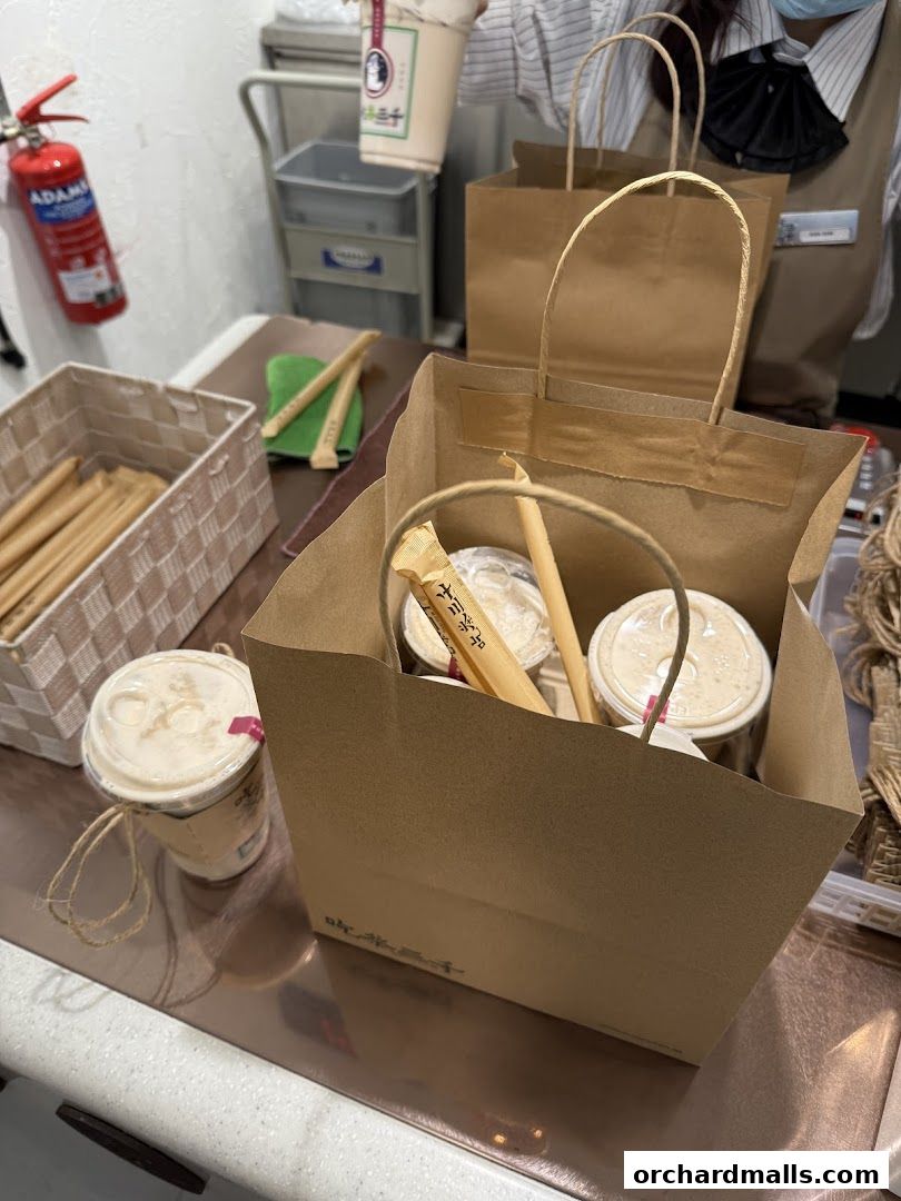 Takeaway drinks and paper bags from CHICHA San Chen at Wheelock Place.