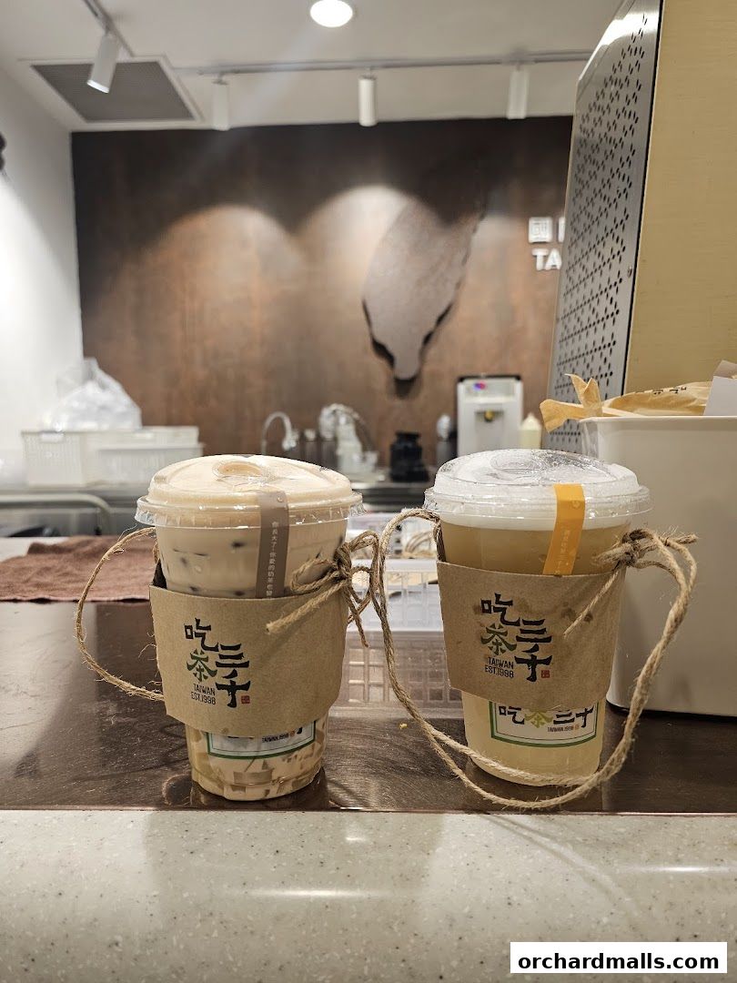 Two refreshing bubble tea drinks from CHICHA San Chen are displayed on a counter.