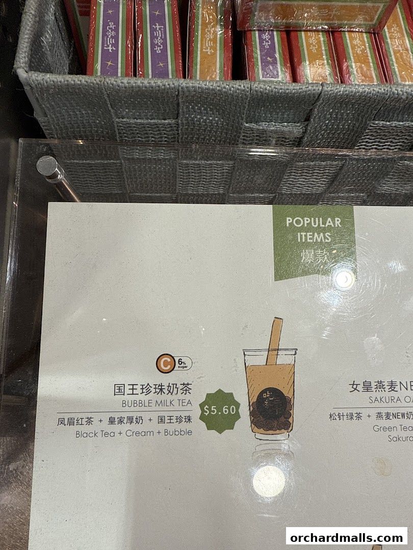 A menu board displays popular bubble milk tea items with prices and ingredients.