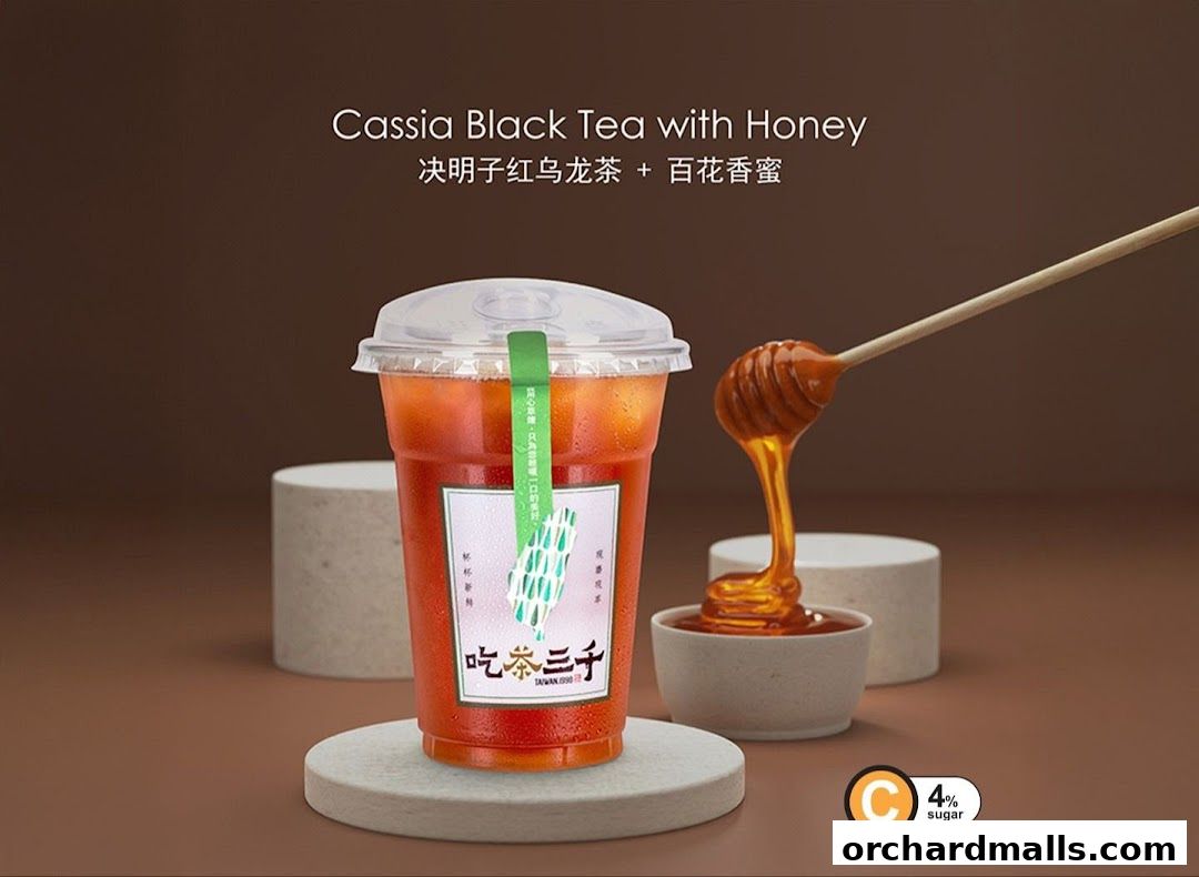A refreshing cup of Cassia Black Tea with Honey, with honey dripping from a dipper.