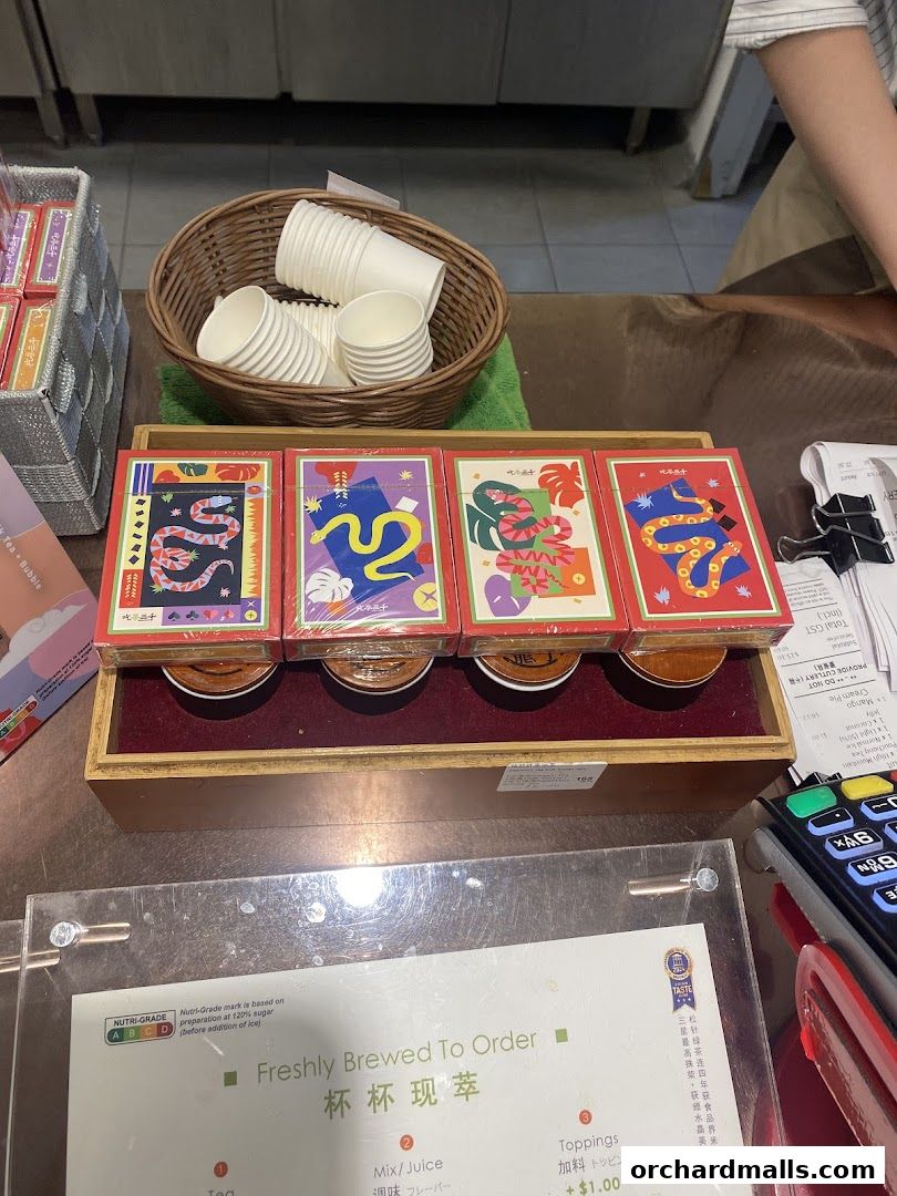 A display of colorful tea boxes and cups at a CHICHA San Chen shop.