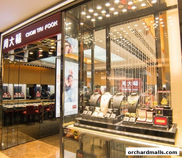 Chow Tai Fook Jewellery store front with displays of necklaces, rings, and gold ornaments.
