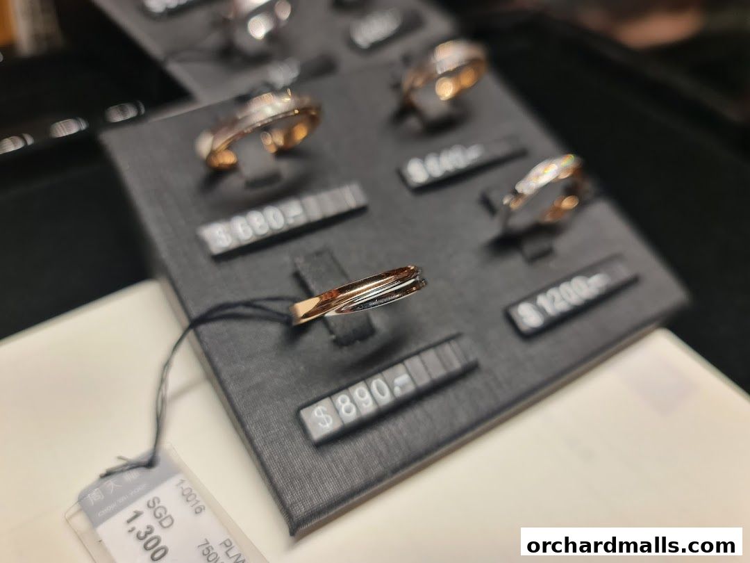 Close-up of elegant rings displayed on a black stand with price tags.