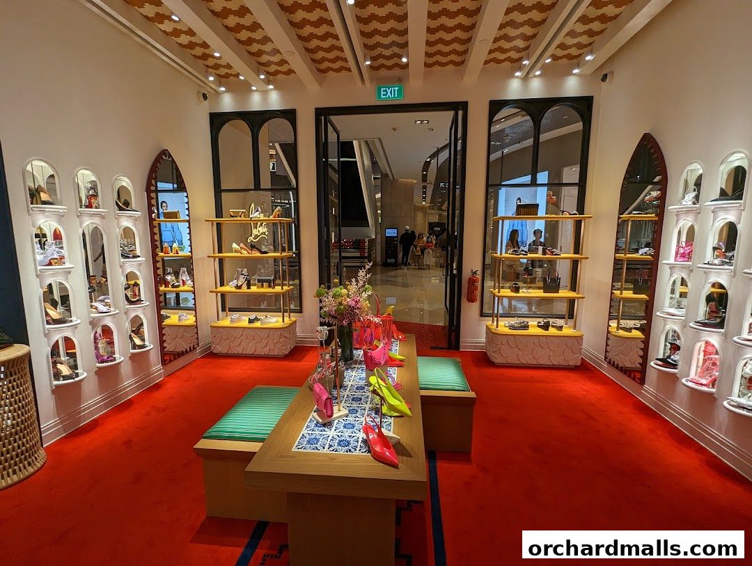 Interior view of a Christian Louboutin store showcasing shoes on display shelves and a central table.