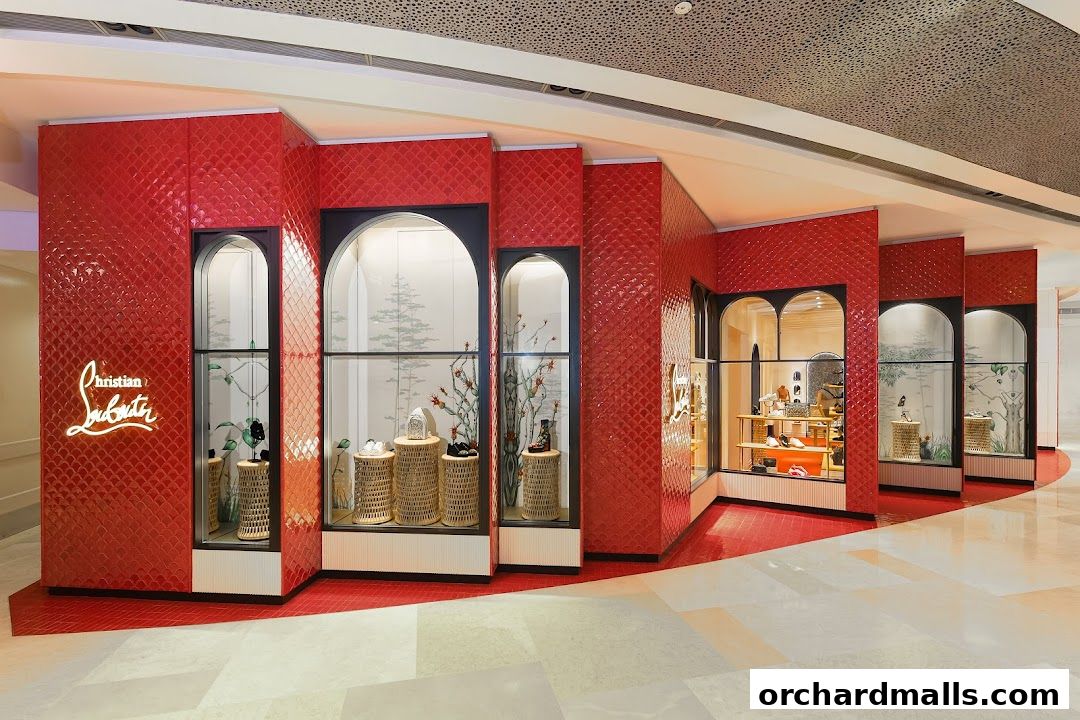 The Christian Louboutin Singapore ION Orchard store features a striking red tiled facade with illuminated displays.