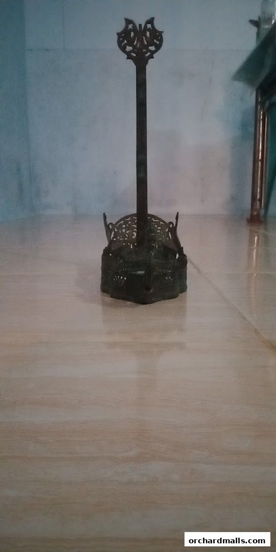 An ornate, antique-style metal stand with intricate detailing.