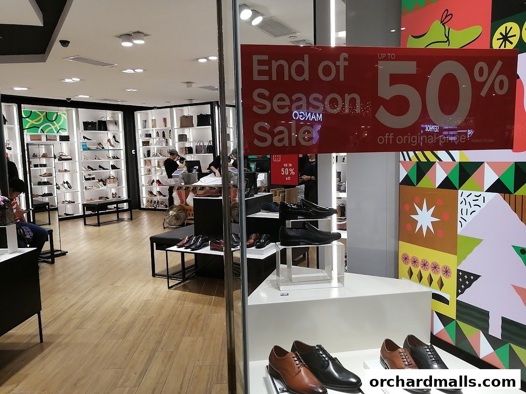 Interior view of a Clarks shoe store with a large 'End of Season Sale' banner.