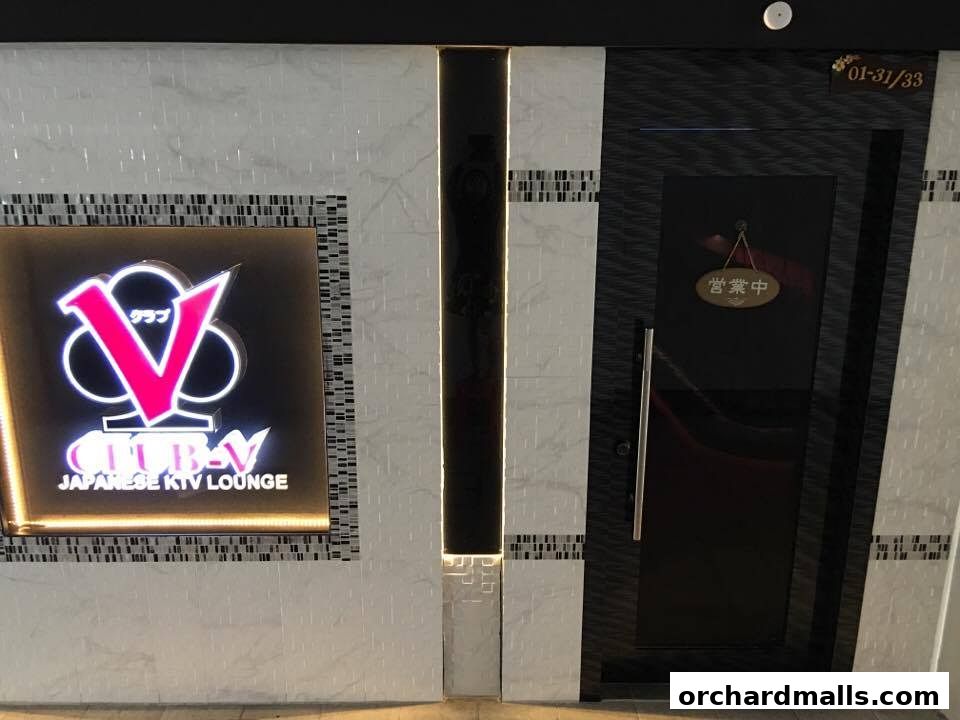 The entrance to CLUB-V Japanese KTV Lounge with a lit sign and an 'Open' sign.
