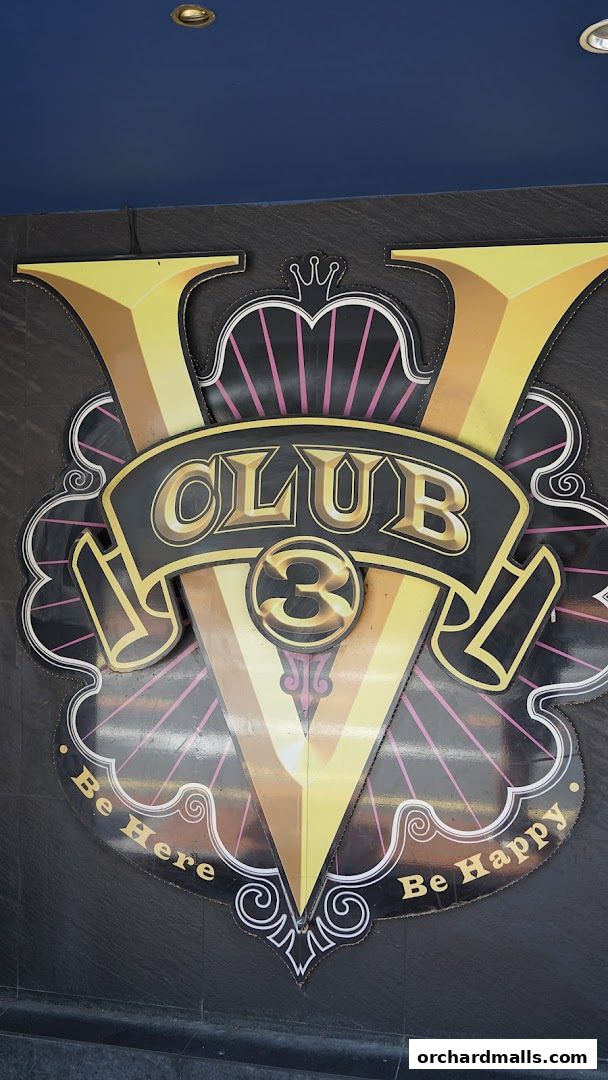 A large, stylized sign for CLUB-V Bistro bar with the slogan 'Be Here Be Happy'.