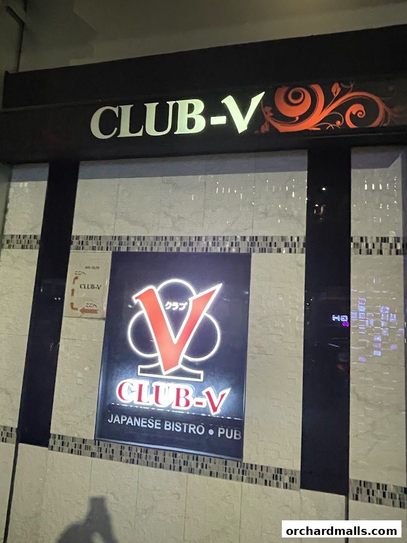The exterior of CLUB-V, a Japanese bistro and pub, with illuminated signage.