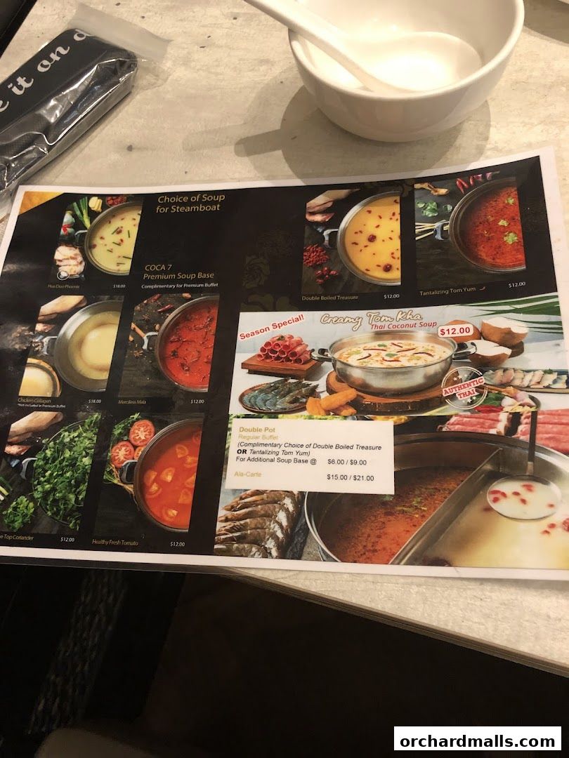 A menu featuring various soup bases for steamboat, including Tom Yum and Thai Coconut Soup.