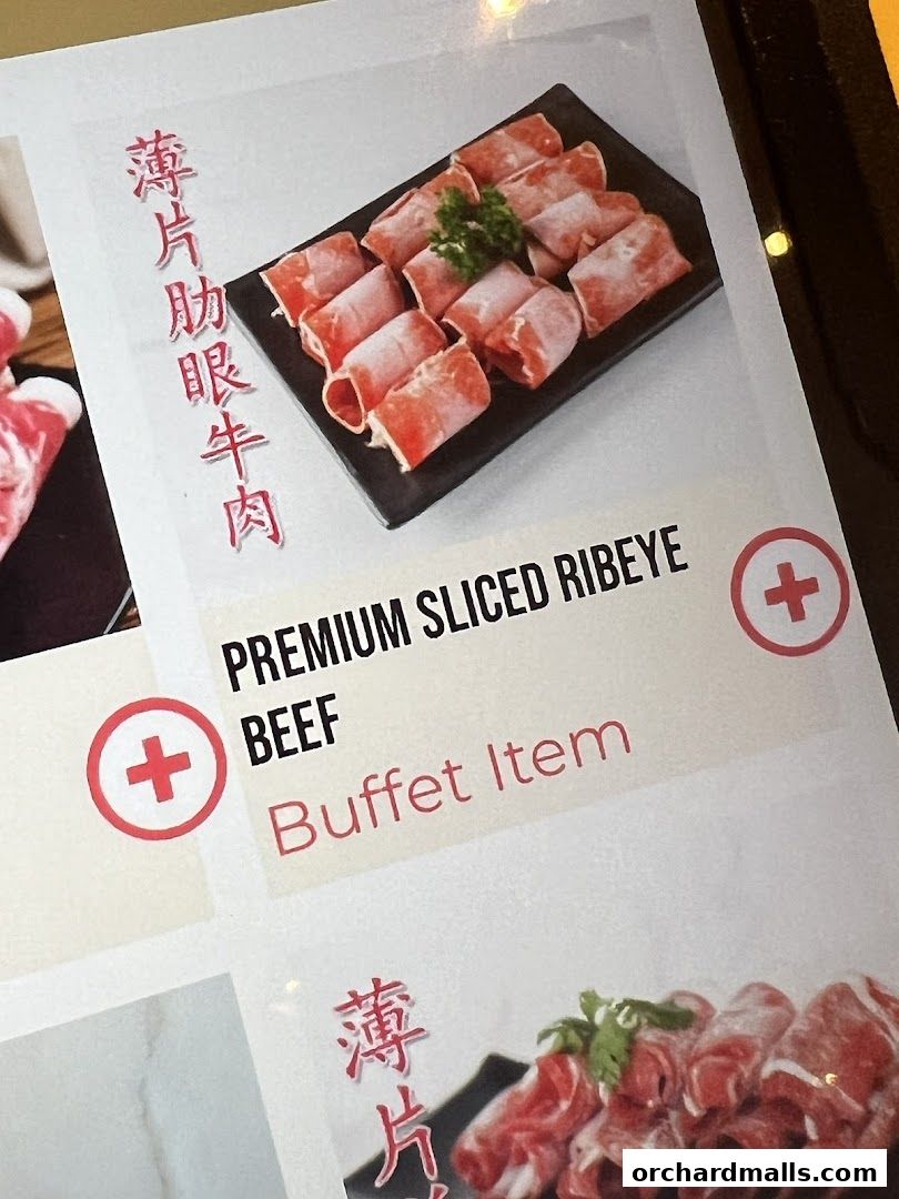 A menu item featuring premium sliced ribeye beef, presented as a buffet item.