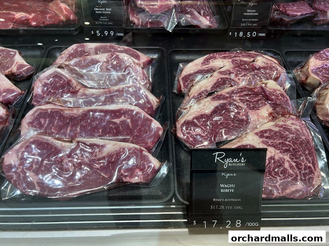 A display of premium, vacuum-sealed cuts of beef, including Wagyu Ribeye and Tenderloin.
