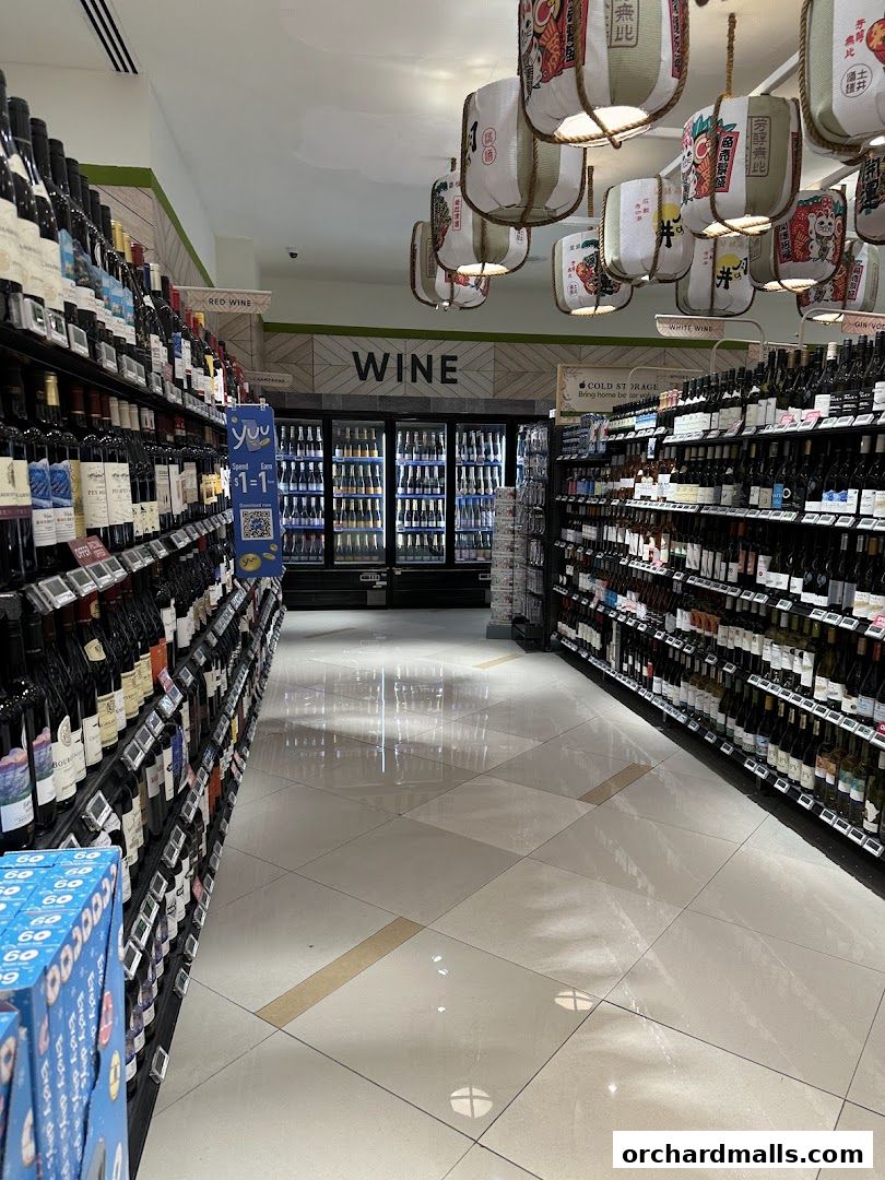 A wide aisle in a wine section of a supermarket with shelves stocked with bottles.