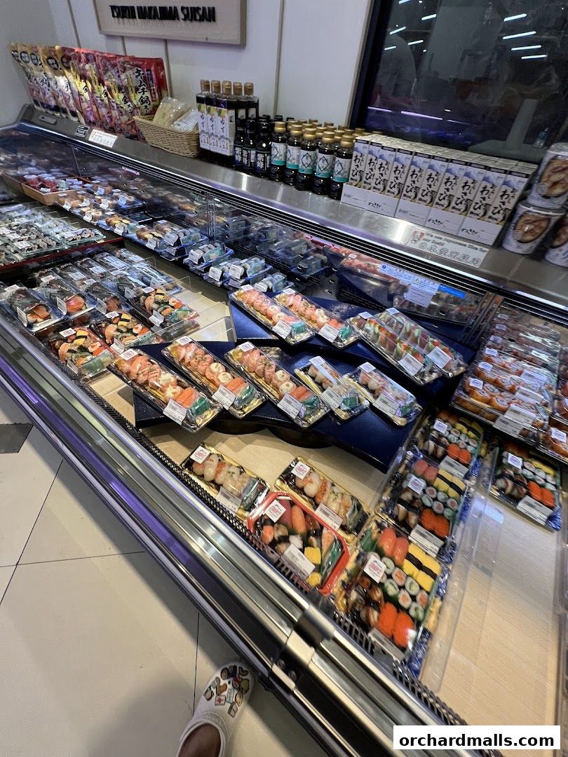 A display of pre-packaged sushi and Japanese food items in a refrigerated case.