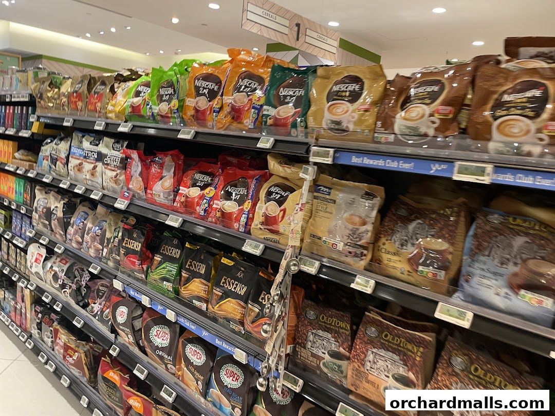 Shelves stocked with various brands of coffee and cereal products in a supermarket.