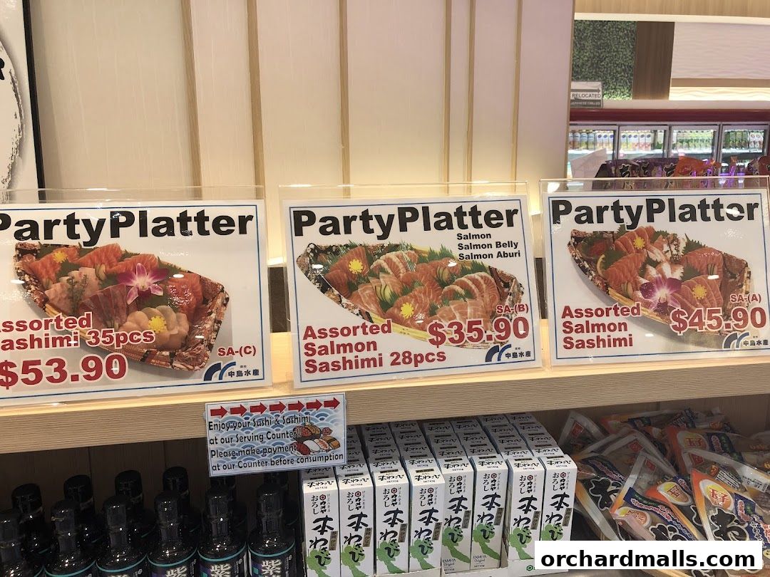 Party platters of assorted sashimi and salmon sashimi are displayed for sale.