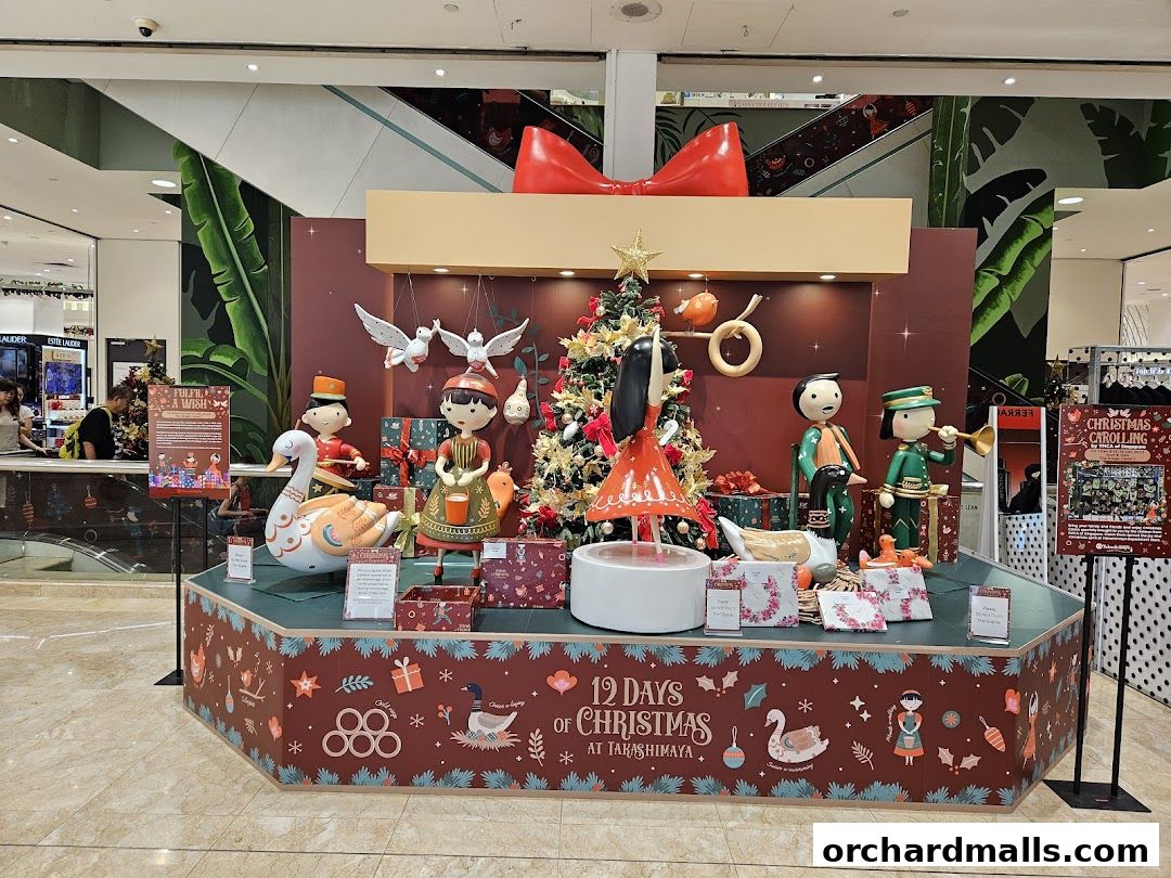 A festive Christmas display with animated figures and a Christmas tree at Takashimaya.