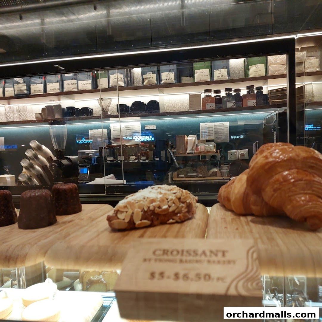 A display of freshly baked pastries and coffee beans at Common Man Coffee Roasters.